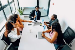 Business professionals engage in a collaborative meeting in a bright Lagos office.